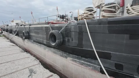 Large Black Oil Cargo Ship Moored at Industrial Harbor Dock Stock Footage 338107223