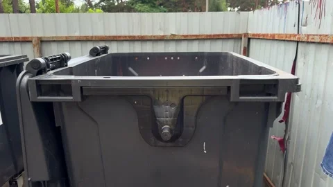 Large black plastic waste container dumpster outdoors Stock-Footage 339366644