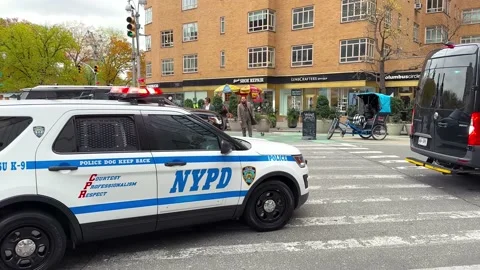 Large Black Security Van Driving Past Followed By NYPD Police Car In New Stock Footage 231092017