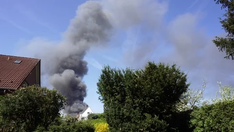 Large Black Smoke Clouds, Fire in Town 動画素材 98354304