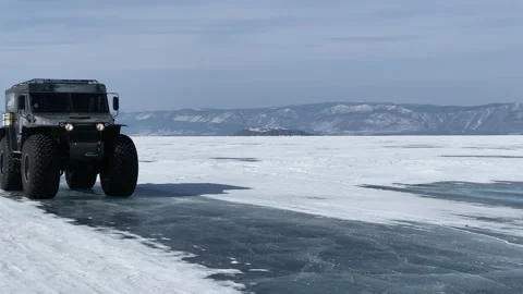 Large black SUV on huge studded wheels Video stock 151187726