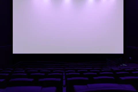 Large blank white cinema screen in dark modern movie theater Stock Photos