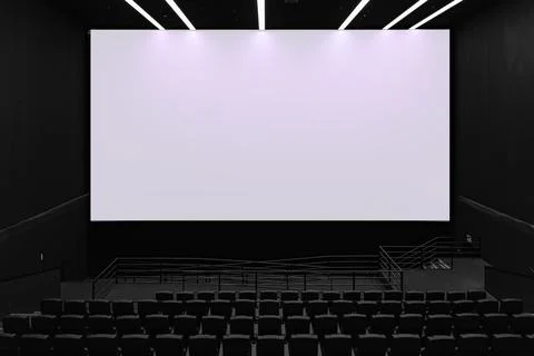Large blank white cinema screen in dark modern movie theater Stock Photos