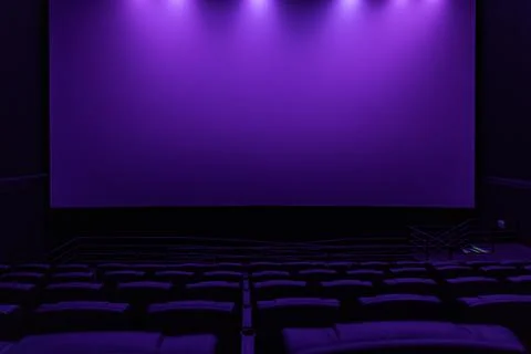 Large blank white cinema screen in dark modern movie theater Stock Photos