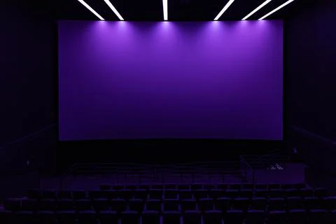 Large blank white cinema screen in dark modern movie theater Stock Photos