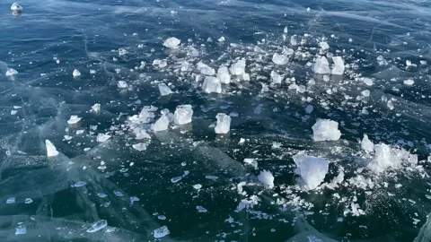 A large block of ice breaks on the blue ice of frozen Lake Baikal Stock-Footage 151188455