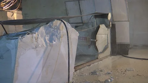 Large block of marble cut by a band saw in carrara Stock Footage 128918064
