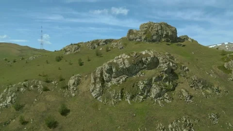 Large block of stone, Wind turbines and antenna. Pushkin Pass Armenia. Stock Footage 254460872