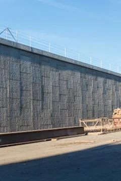 Large block wall of an elevated street with I beams and construction material Stock Photos