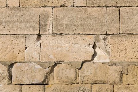 Large blocks beige rectangles cobblestones part powerful protective wall base Stockfoto's