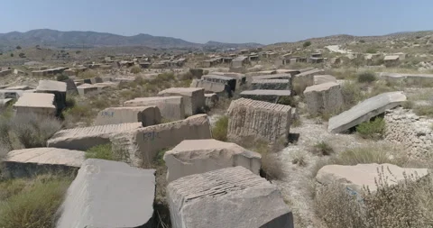 Large blocks of stone from abandoned quarry scattered in the desert Stock Footage 210233100