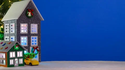 On a large blue background, a gray and brown-green house with a yellow car Stock Footage 294322476
