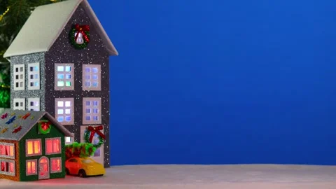 On a large blue background, a gray and brown-green house with a yellow car Stock Footage 294322477