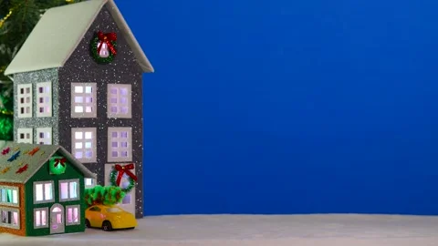 On a large blue background, a gray and brown-green house with a yellow car Video stock 294322479