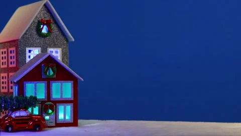 On a large blue background multi-colored houses and a red car Video stock 294491944