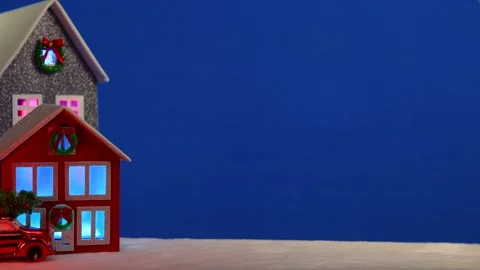 On a large blue background there are decorated houses and a red car Stock Footage 294492175