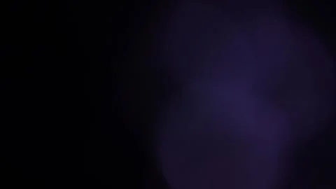 Large blue bokeh flashing on the right in the blackness Stock Footage 318914552