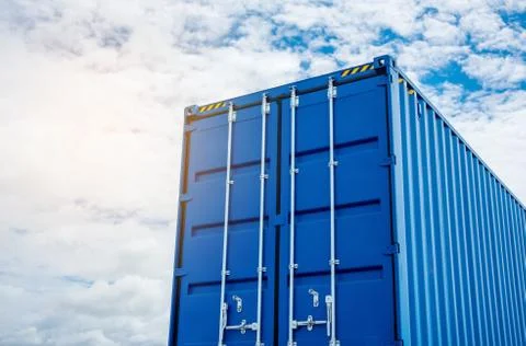 A large blue container is placed on top of a truck. Stock Photos