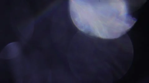 Large blue prismatic bokeh in the black Видео 318920543
