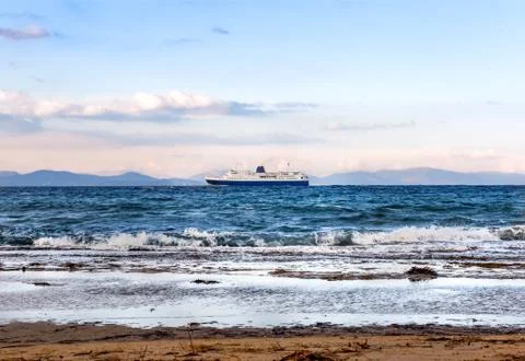 Large blue-white ferry ship leaving port of Rafina on a winter day Stock Photos
