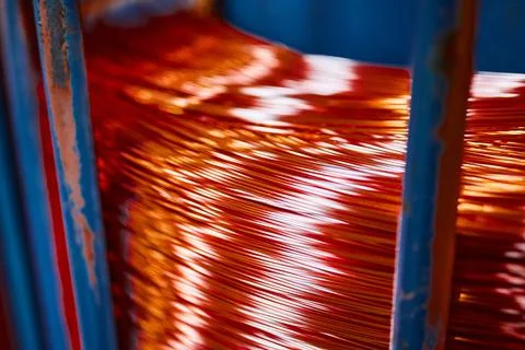 Large bobbin of orange copper wire in light warehouse Stock Photos