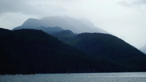 A large body of water with a mountain in the background Stock-Footage 156012045