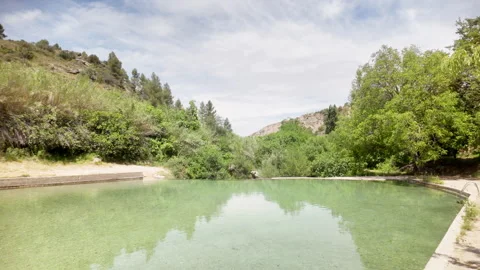 A large body of water with trees in the background Stock Footage 277410473