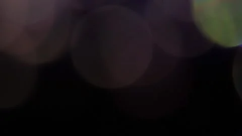 Large bokeh with a glowing light overlay in the dark Vídeo Stock 318663793