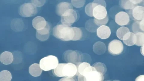 Large bokeh highlights on a blue background. Blurred reflections from water Stock Footage 154649136