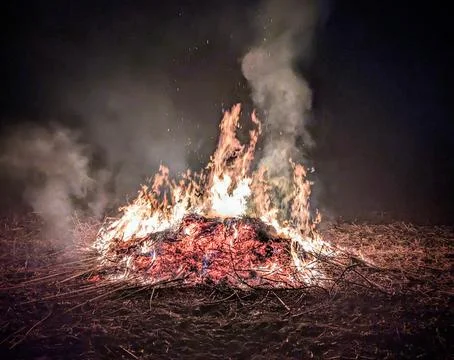 Large bonfire burning at night with high flames and sparks Stock Photos