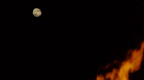 Large bonfire flames  with full moon behind 스톡 동영상 36635651