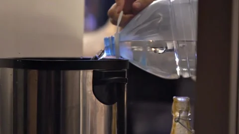 Large bottle into dispenser for making mulled wine, tea or another hot drink Stock Footage 220610839