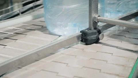 Large bottles with clean water move along conveyor belt Stock-Footage 160714233