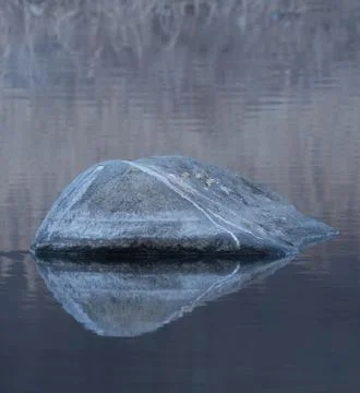 Large boulder in a river Stock Photos