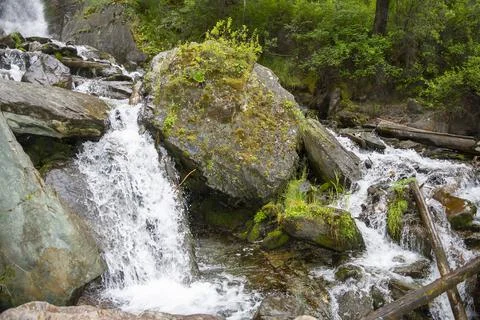 Large boulders on the path of a mountain stream Stock Photos