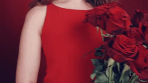 Large bouquet of large red roses in the hands of girls. Stock Footage 102948195