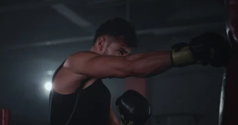 In a large boxing class young attractive guy with perfect muscle boxing hard in Video stock 117052147