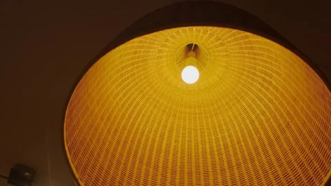 Large braided lampshade with a light bulb Stock Footage 227028466