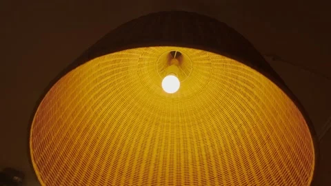 Large braided lampshade with a light bulb Stock Footage 227028828