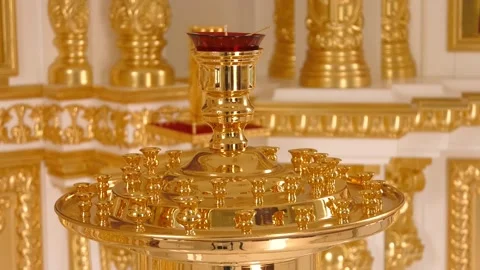 A large brass candlestick without candles standing in an Orthodox church Video stock 223815131