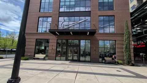 Large brick-and-glass building displaying a prominent white Nike swoosh Video stock 343171704