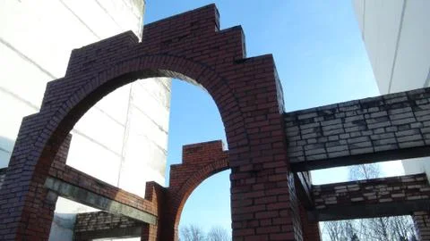 Large brick arch between high rise buildings Stock Photos