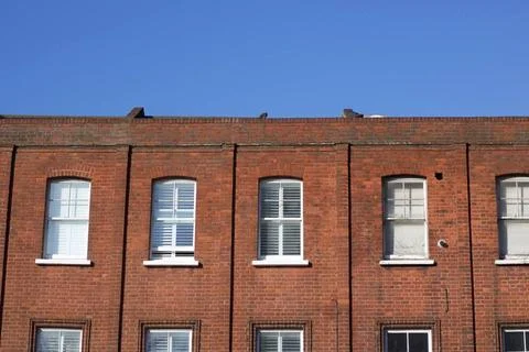 A large brick building with blue sky above A large brick building. High q... Fotos de archivo
