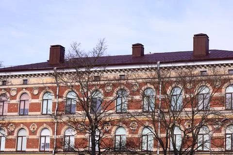 A large brick building with a clock tower, suitable for use in architectural or Stock Photos
