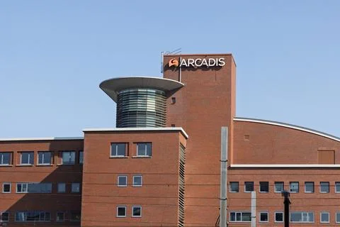 A large brick building with a distinctive circular structure on the roof, fea Stock Photos