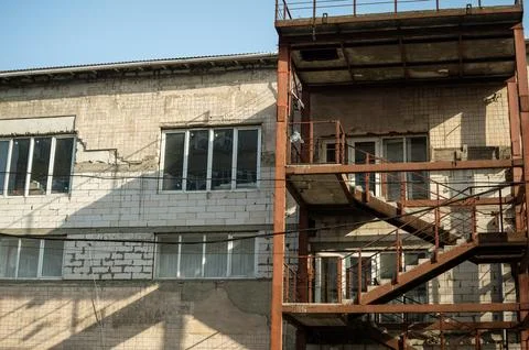 A large brick building with many windows Stock Photos
