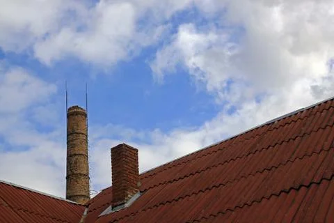Large brick chimney on the background of the bright sky Stock Photos