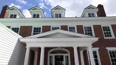Large brick house with white columns and dormer windows Stock Footage 337797045