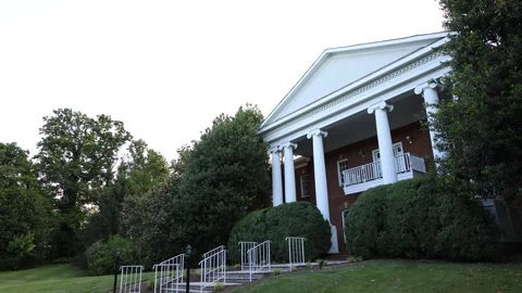 Large brick house with white columns and lawn Stock Footage 337910838
