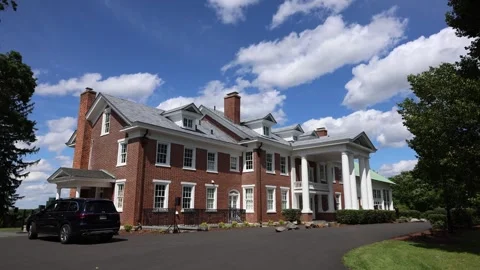 Large brick mansion with white columns and blue sky Stock Footage 337796768